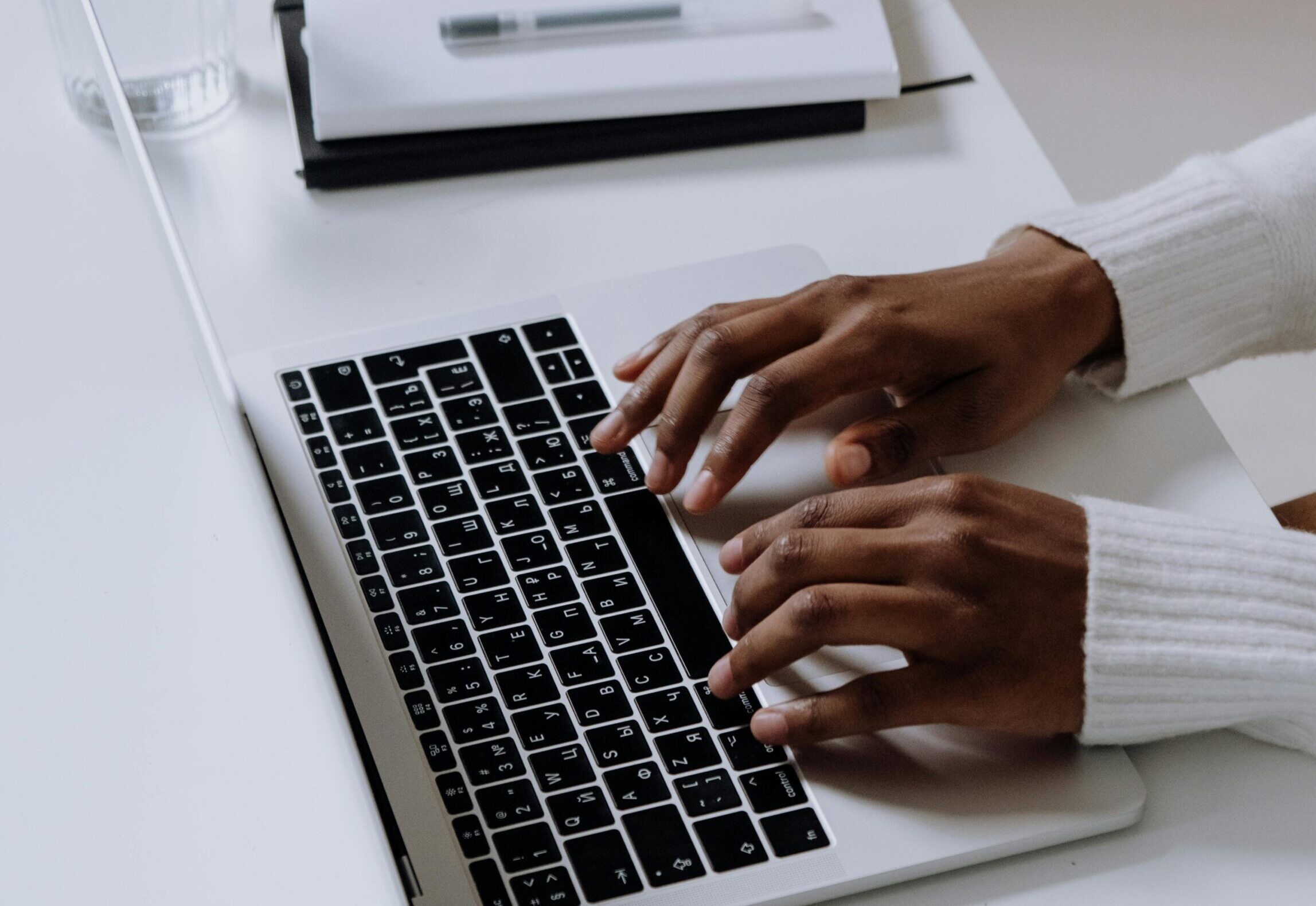 Person typing on a laptop while writing a business blog in 2026