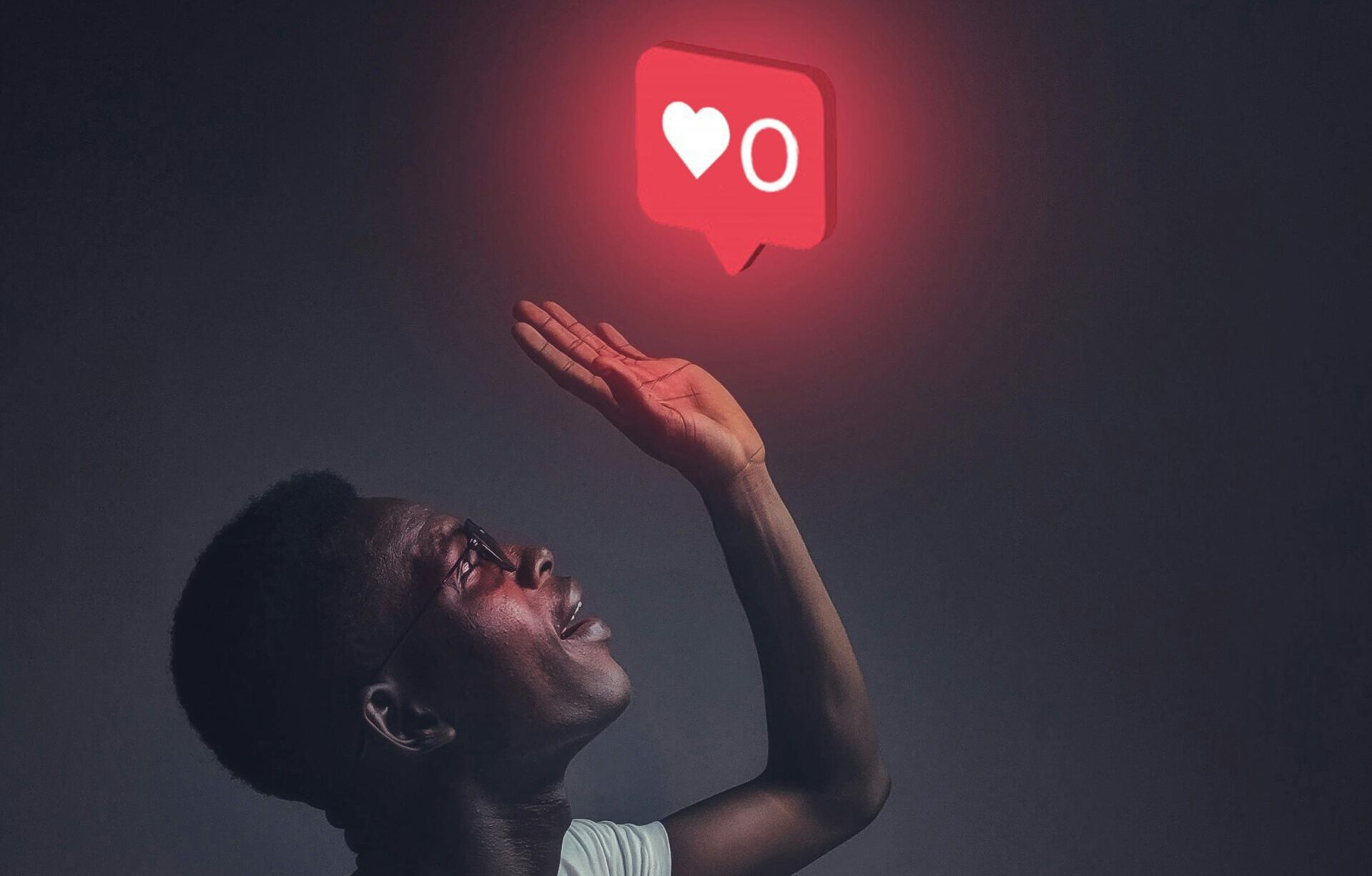 man looking at an icon of social media likes